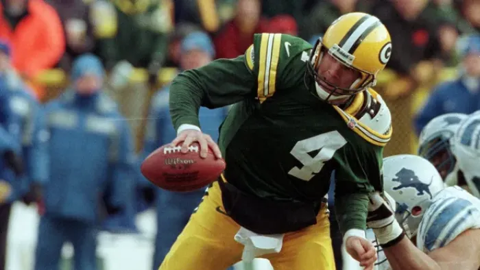 Untold: The Fall of Favre movie: Brett Favre as a Green Bay Packer center in a game resists a tug from an opposing Detroit Lions player