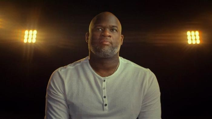 Untold: The Testimony of Vince Young movie: Vince Young sits in a dark room with four spotlights