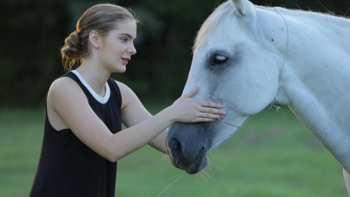 Urban Country Movie: Faith strokes a horse's nose