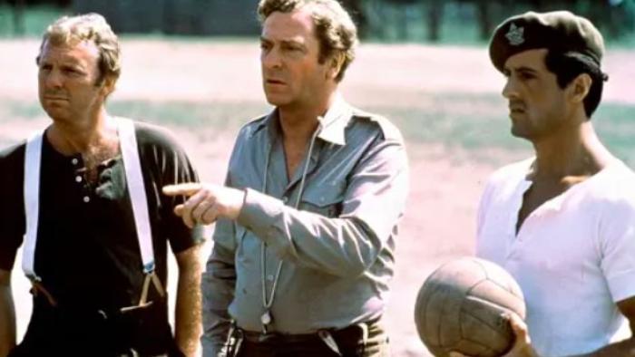 Victory: Bobby Moore, Michael Caine, and Sylvester Stallone stand with soccer ball