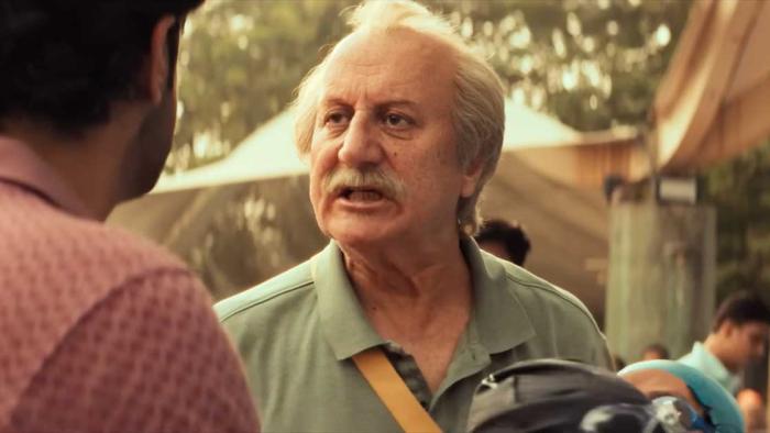 Vijay 69 movie: Older Indian man with white hair and mustache center speaks outdoors with Indian man with brown hair left