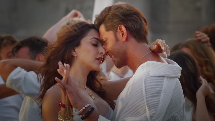 War 2: Couple in an intimate dance pose surrounded by other dancers