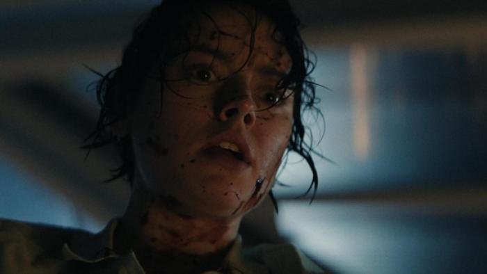 We Bury the Dead movie: Daisy Ridley, with blood splatter on her face, looks shocked and scared