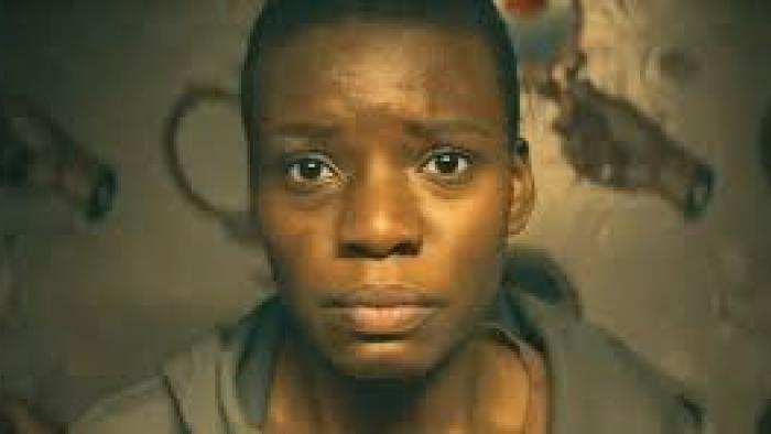 Weathering: closeup of Black woman's face looking worried or in pain
