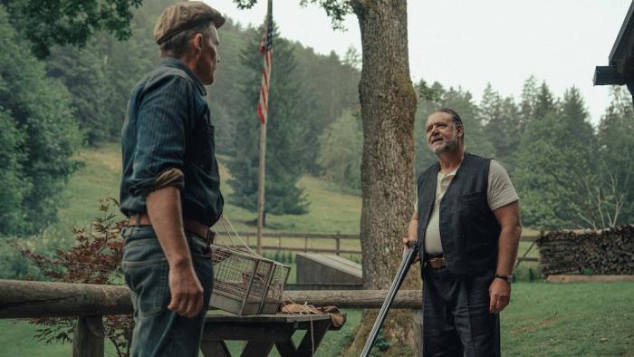 The Weight Movie: Murphy speaks to Clancy on a front porch, Clancy holding a rifle that's pointed downward