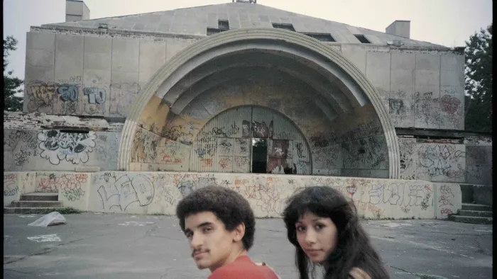 till from Wild Style: In the background, an amphitheater covered with graffiti logos and messages, and in the foreground, Raymond a.k.a. Zero ("Lee" G