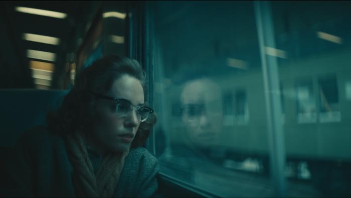 Wildcat Movie: Flannery O'Connor (Maya Hawke) rides the train, looking lost in thought