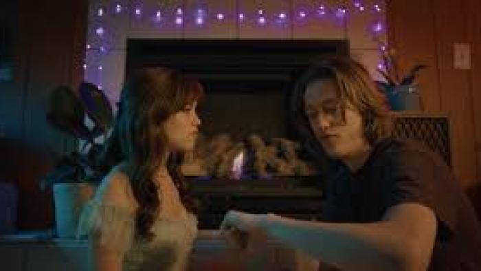 Winter Spring Summer or Fall: Jenna Ortega and Percy Hynes White sit by a fire.