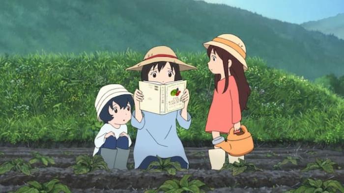 Wolf Children Movie: A mom looks confusedly at a book as her two young kids look on, all of them in a farm field