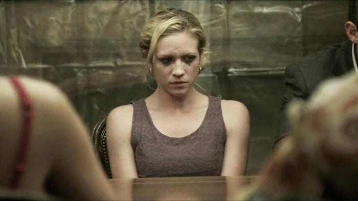 Would You Rather: Woman sitting at a table, looking serious, with a blurred background