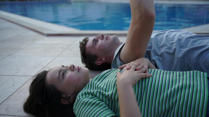 Aftersun: Paul Mescal and Frankie Corio lying by a pool