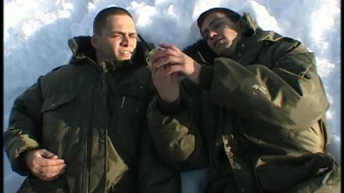 Yossi & Jagger: Two Israeli soldiers lay together in the snow looking at a portable radio