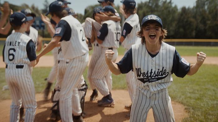 You Gotta Believe Movie: A Little League player shows his elation at winning while the team celebrates behind him