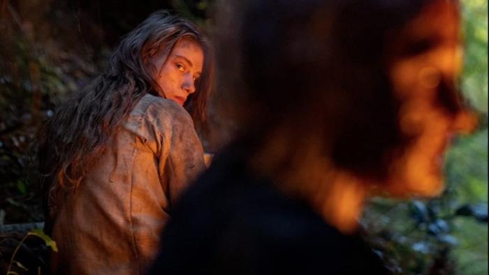 You Won't Be Alone: Sara Kilmoska looks over her shoulder at blurred images of witch's face in foreground