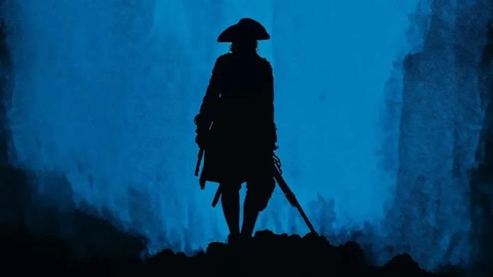 Young Washington movie: A shadowed outline of William Franklyn-Miller at night holding a gun
