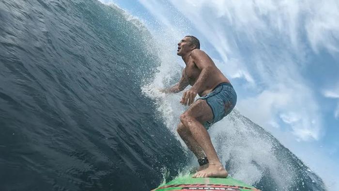 100 Foot Wave TV show screenshot 3: McNamara surfs a big wave