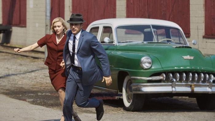 11.22.63 TV show: A man and woman are running from a 1960s green car.