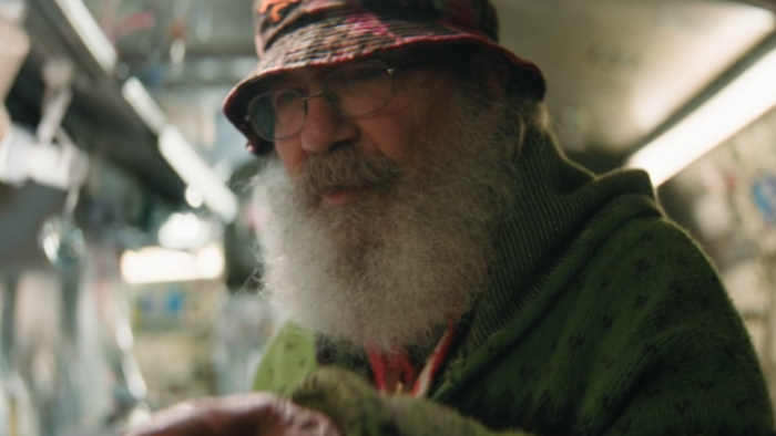 4x20: Quick Hits TV show screenshot 3: a glass artist affected by Operation Pipe Dream; he has a long gray beard and a hat