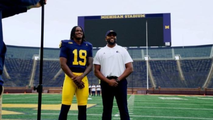 5 Star TV show screenshot: University of Michigan quarterback, Bryce Underwood, stands on the field next to his coach