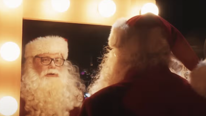 A Nonsense Christmas with Sabrina Carpenter screenshot 3: Sean Astin looks in mirror dressed as Santa.