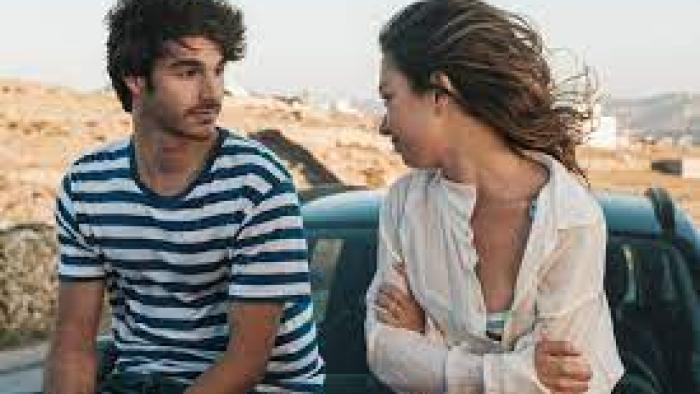 A Perfect Story TV show screenshot #2: a young man and woman look at each other while sitting on the hood of a car