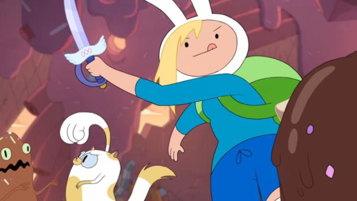 Adventure Time: Fionna & Cake: Fionna wears a clue shirt and skirt with white rabbit ears, she is holding a sword high in the air. Beside her, Cake is raising her paw to bat at a small, brown creature with a crooked mouth