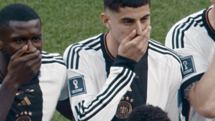 All or Nothing: The German National Team in Qatar screenshot 3: Teammates cover their mouths in protest when posing for picture on field.. 