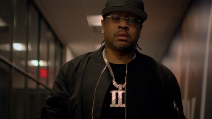 Allen Iv3rson screenshot 2: Older Allen Iverson walking down hall wearing black baseball cap and gold chain with Roman numeral three