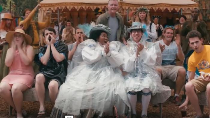 American Princess TV Series: An audience including two people dressed in elaborate white Renaissance costumes applauds. 