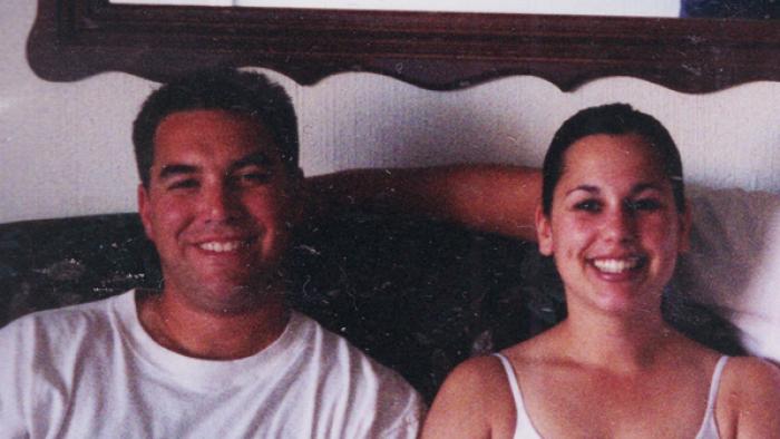 American Murder: Laci Peterson TV show screenshot: Scott and Laci Peterson sit smiling next to each other