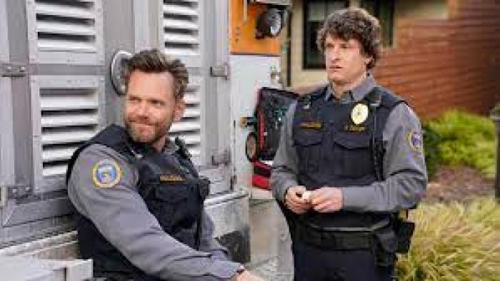 Animal Control TV show: two White men in Animal Control uniforms look toward something
