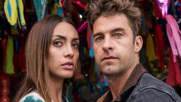 Animal Kingdom TV Show: A close-up on a woman and man's faces, both looking neutral