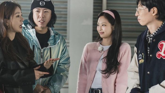 Se-Chan Yang, Jennie Kim, and Yoo Jae-suk stand in a parking garage with Oh Na-ra, who speaks while gesturing with her hands
