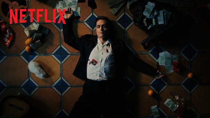Berlin and the Lady with an Ermine: Man in a suit with a bullet hole in his chest lying on tile floor, surrounded by scattered items.
