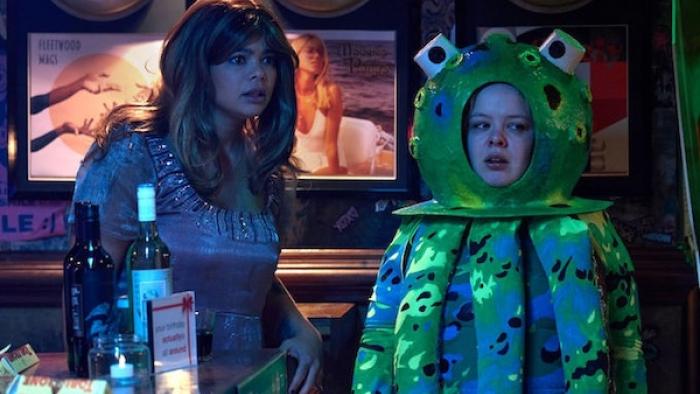 Big Mood TV show screenshot 2: Eddie and Maggie, dressed in Love Actually-themed costumes, stand in a bar looking slightly aghast at something
