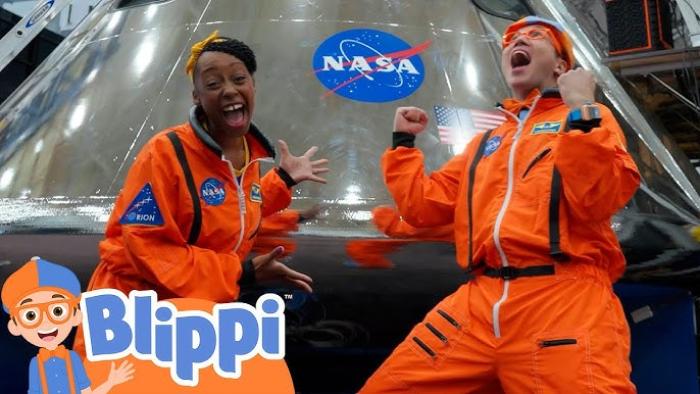 Blippi's NASA Astronaut Adventure TV: Meekah and Blippi wear bright orange spacesuits and scream excitedly in front of a NASA symbol.
