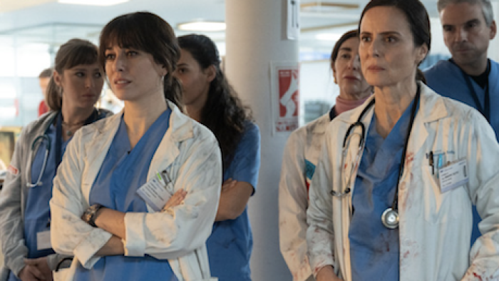Breathless screenshot 2: Doctors stand in blue scrubs and white bloody coats. 