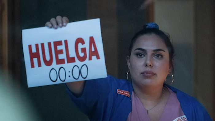 Breathless screenshot 3: A nurse holds a sign to the window that says Strike. 