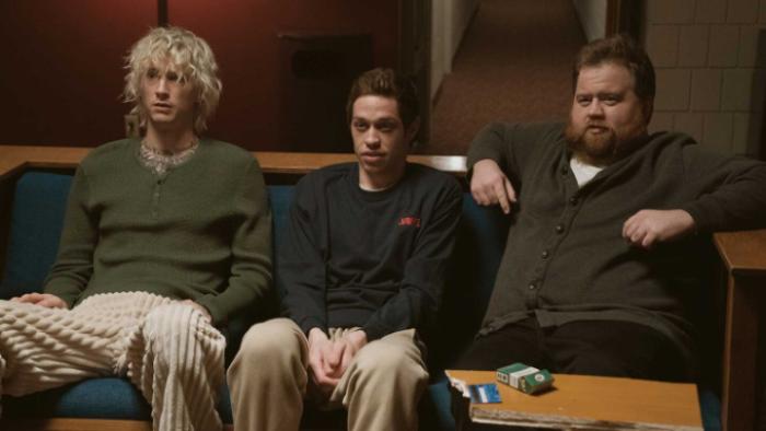 Bupkis TV show screenshot: Pete sits between two friends on a couch in a living room; all look disheveled and shell-shocked