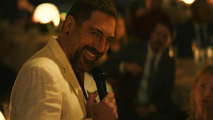 Cape Fear TV show screenshot 2: Javier Bardem laughs into a microphone. He wears a white linen suit jacket.