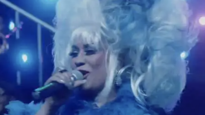 Celia TV show: Aymeé Nuviola plays elder Celia in white and blue dress and large wig at Madison Square Garden.