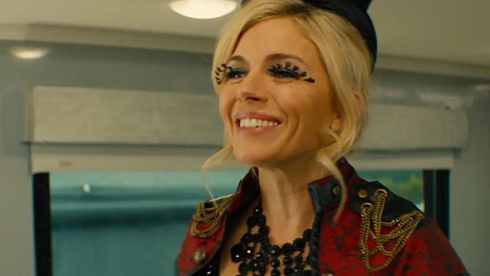 Chivalry TV show screenshot 2: Lark, wearing a red and black showgirl costume and feathery eyelashes, smiles widely