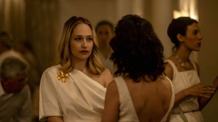 City on Fire TV show: a woman (Jemima Kirke) chats at an upper-class party