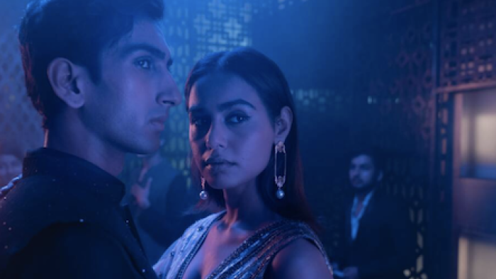 Class TV show: Moses and Koel dance together on dark blue-lit dance floor.