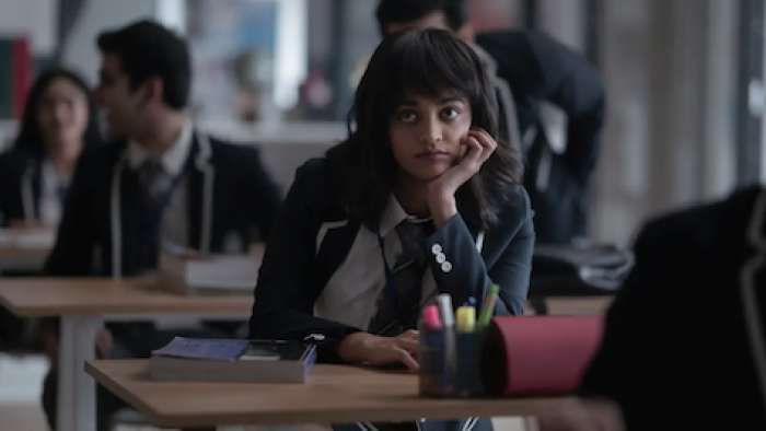 Class TV show: Shuhani Ahuja sits in classroom resting chin in hand staring into space.