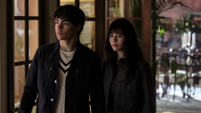 Coven Academy TV show screenshot 1: Jake and Briar stand together in the hallway at school, wearing street clothes and determined expressions