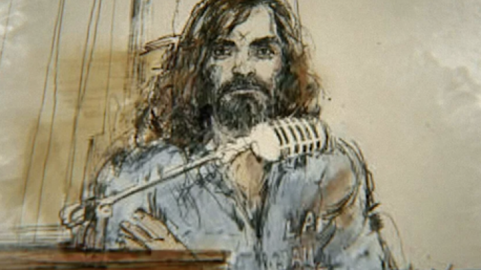 Conversations with a Killer: The Charles Manson Tapes TV show screenshot 2: Courtroom sketch of Charles Manson behind a microphone.