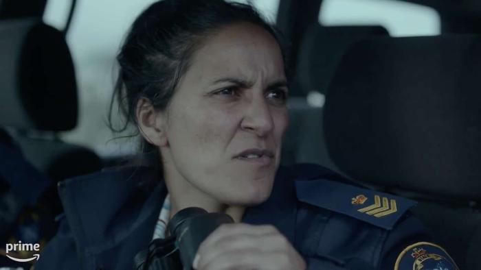 : Madeleine Sami as Detective Eddie Radcliffe, sitting in a car.