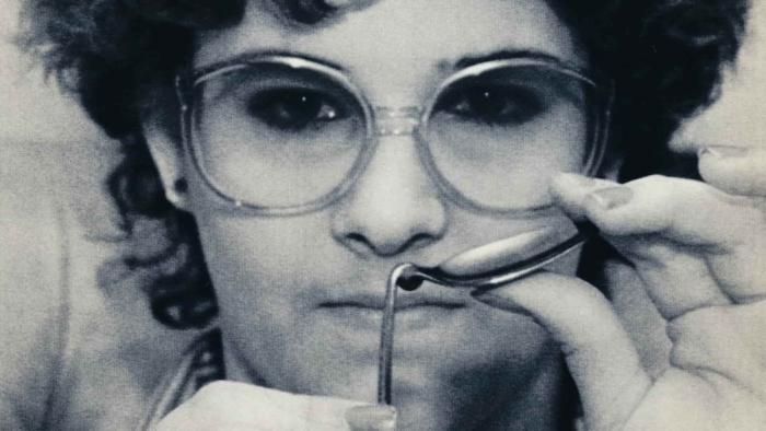 Demon and Saviors TV Show Screenshot 1: Christina Boyer pictured in her teen years, bending a spoon backwards.