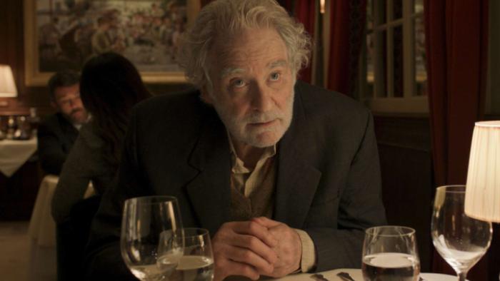 Disclaimer: Stephen sits at a dinner table in a restaurant, looking balefully at something; he wears a suit
